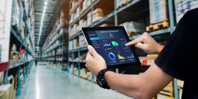 Silverline Shipping truck carrying a container from a busy port for Port Drayage and Haulage services